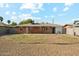 A backyard with a small patch of grass surrounded by decorative rock at 2015 W Weldon Ave, Phoenix, AZ 85015