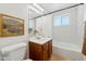Bright bathroom featuring a tub with a shower curtain and white subway tile with ceramic tile flooring at 2015 W Weldon Ave, Phoenix, AZ 85015