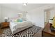 A bright bedroom boasts a geometric rug, a light grey platform bed, and white walls at 2015 W Weldon Ave, Phoenix, AZ 85015