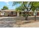 Single-story brick home featuring covered parking and xeriscaped front yard for easy maintenance at 2015 W Weldon Ave, Phoenix, AZ 85015