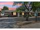 Charming single-story brick home featuring a covered parking area and a beautifully xeriscaped front yard at 2015 W Weldon Ave, Phoenix, AZ 85015