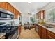 Well-lit kitchen with wooden cabinets, granite countertops and stainless steel appliances at 2015 W Weldon Ave, Phoenix, AZ 85015