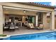 Outdoor patio featuring a pool, fireplace, and outdoor seating overlooking the backyard at 2114 N Canelo Hls, Mesa, AZ 85207