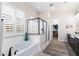 Elegant bathroom with a soaking tub, a glass-enclosed shower, and a walk-in closet, offering a spa-like experience at 2114 N Canelo Hls, Mesa, AZ 85207