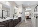 Bright bathroom with dual vanities, modern fixtures, and an open layout leading to the bedroom, providing comfort and style at 2114 N Canelo Hls, Mesa, AZ 85207