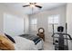 Bright bedroom features wood-style tile, a ceiling fan, shutters, and closet with sliding doors at 2114 N Canelo Hls, Mesa, AZ 85207