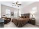 Cozy bedroom with ceiling fan, shutters, comfortable chair, and elegant furnishings at 2114 N Canelo Hls, Mesa, AZ 85207