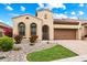 Charming Mediterranean-style home with a well-manicured lawn, stone accents, and a private driveway at 2114 N Canelo Hls, Mesa, AZ 85207