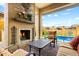 Inviting patio with cozy fireplace, comfortable outdoor seating, and a clear view of the refreshing pool at 2114 N Canelo Hls, Mesa, AZ 85207