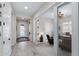 Bright hallway leading to a modern office with glass doors, showcasing the home's open and airy design at 2114 N Canelo Hls, Mesa, AZ 85207