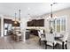 Elegant kitchen with dark wood cabinets, a granite island with seating, and stainless steel appliances at 2114 N Canelo Hls, Mesa, AZ 85207