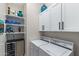 Laundry room features white washer and dryer, white shelves, and beverage cooler at 2114 N Canelo Hls, Mesa, AZ 85207