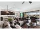 Inviting living room with a comfortable leather sofa and seamless indoor-outdoor flow to a private pool area at 2114 N Canelo Hls, Mesa, AZ 85207