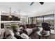Spacious living room featuring a dark brown leather sofa and open kitchen area at 2114 N Canelo Hls, Mesa, AZ 85207