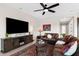 Cozy living room with modern ceiling fan, plush seating, and decorative rug at 2114 N Canelo Hls, Mesa, AZ 85207