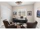 Stylish home office with a large desk, comfortable seating, and ample natural light, ideal for productivity at 2114 N Canelo Hls, Mesa, AZ 85207