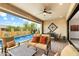 Relaxing covered patio showcases comfortable seating and a view of the pool with water features for outdoor enjoyment at 2114 N Canelo Hls, Mesa, AZ 85207