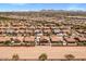 Charming aerial shot of desert home boasting backyard oasis with pool, covered patio, and lush landscaping at 21200 E Camacho Rd, Queen Creek, AZ 85142