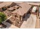 Aerial view of property with desert landscaping and a private driveway and garage at 21200 E Camacho Rd, Queen Creek, AZ 85142