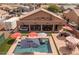 Expansive backyard with a pool, spa, outdoor kitchen, and covered patio for entertaining at 21200 E Camacho Rd, Queen Creek, AZ 85142