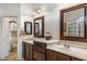 Elegant bathroom vanity with marble countertops and framed mirrors at 21200 E Camacho Rd, Queen Creek, AZ 85142