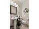 Half bathroom featuring pedestal sink, mirror, and toilet at 21200 E Camacho Rd, Queen Creek, AZ 85142