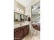 Bathroom with marble countertops, framed mirrors, and access to the bedroom at 21200 E Camacho Rd, Queen Creek, AZ 85142
