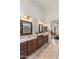 Bathroom featuring dual sinks, marble countertops, and framed mirrors at 21200 E Camacho Rd, Queen Creek, AZ 85142