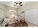 Cozy bedroom featuring two beds, a ceiling fan, and a sliding door closet at 21200 E Camacho Rd, Queen Creek, AZ 85142