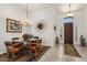 Elegant dining room with stylish lighting, designer rug, and comfortable seating at 21200 E Camacho Rd, Queen Creek, AZ 85142