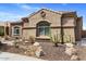 Charming single-story home featuring desert landscaping and a well-maintained stucco facade at 21200 E Camacho Rd, Queen Creek, AZ 85142
