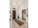 Welcoming foyer with decorative rug, arched entryways, and neutral color palette at 21200 E Camacho Rd, Queen Creek, AZ 85142