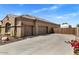 Spacious three-car garage providing ample parking and storage, with low water landscaping at 21200 E Camacho Rd, Queen Creek, AZ 85142