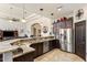 Open kitchen with granite counters, stainless appliances, and dark wood cabinets at 21200 E Camacho Rd, Queen Creek, AZ 85142