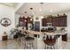 Beautiful kitchen featuring granite countertops, pendant lighting, and dark wood cabinetry at 21200 E Camacho Rd, Queen Creek, AZ 85142