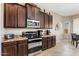 Kitchen area featuring stainless steel appliances, wood cabinets, and granite counters at 21200 E Camacho Rd, Queen Creek, AZ 85142