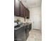 Laundry room with modern washer and dryer, ample storage, and sink at 21200 E Camacho Rd, Queen Creek, AZ 85142
