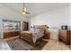 Primary bedroom featuring a ceiling fan, area rug, and a large window at 21200 E Camacho Rd, Queen Creek, AZ 85142