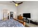 Primary bedroom boasts a ceiling fan, a bed with patterned bedding, and a dresser at 21200 E Camacho Rd, Queen Creek, AZ 85142