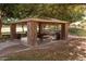 Stone pavilion with picnic tables and BBQ grill in the common community area at 21200 E Camacho Rd, Queen Creek, AZ 85142