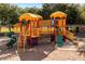 Colorful playground structure with slides, bridges, and climbing features in a community park at 21200 E Camacho Rd, Queen Creek, AZ 85142