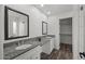 Bright bathroom featuring dual sinks, granite countertops, and a spacious walk-in closet at 2152 E Casitas Del Rio Dr, Phoenix, AZ 85024