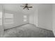 Large bedroom with plush carpet, windows, and ceiling fan at 2152 E Casitas Del Rio Dr, Phoenix, AZ 85024