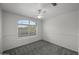 Empty bedroom showcasing a ceiling fan and a window with natural light at 2152 E Casitas Del Rio Dr, Phoenix, AZ 85024