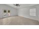This bedroom has a ceiling fan, tile floor, and French doors to the backyard at 2152 E Casitas Del Rio Dr, Phoenix, AZ 85024