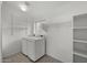 Spacious laundry room with washer, dryer, and built-in shelves at 2152 E Casitas Del Rio Dr, Phoenix, AZ 85024