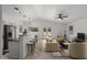 Bright living room features an open floor plan, tile flooring, and a bar counter overlooking the backyard pool at 2152 E Casitas Del Rio Dr, Phoenix, AZ 85024