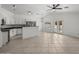 Spacious living room with tiled flooring, neutral paint, ceiling fan, and access to backyard pool at 2152 E Casitas Del Rio Dr, Phoenix, AZ 85024