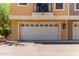 A townhome exterior with a closed garage door and a small balcony above at 22125 N 29Th Ave # 137, Phoenix, AZ 85027