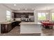 Stylish eat-in kitchen featuring granite countertops, stainless steel appliances, and dark cabinetry at 22125 N 29Th Ave # 137, Phoenix, AZ 85027